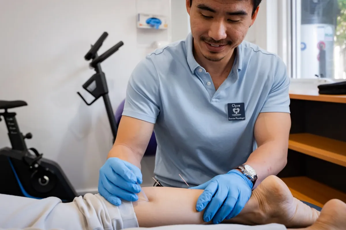 Clyve Tan treating a client in the exercise physiology room