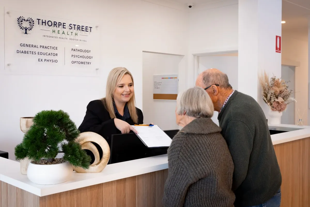 A patient being helped at the reception counter at Thorpe Street Health