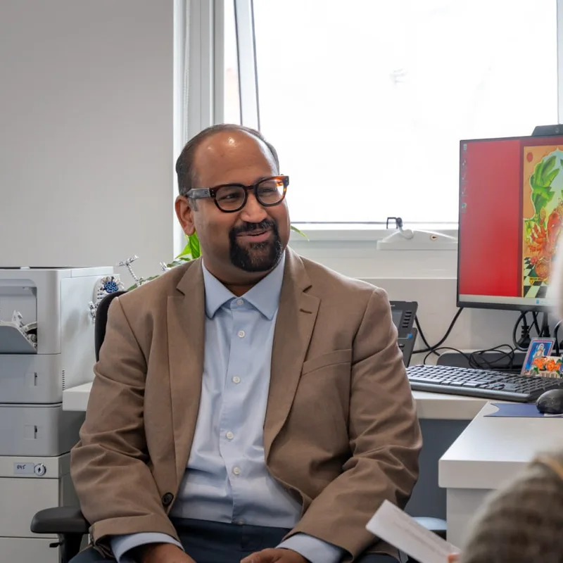 A doctor at Thorpe Street Health talking with a patient in a consulting room