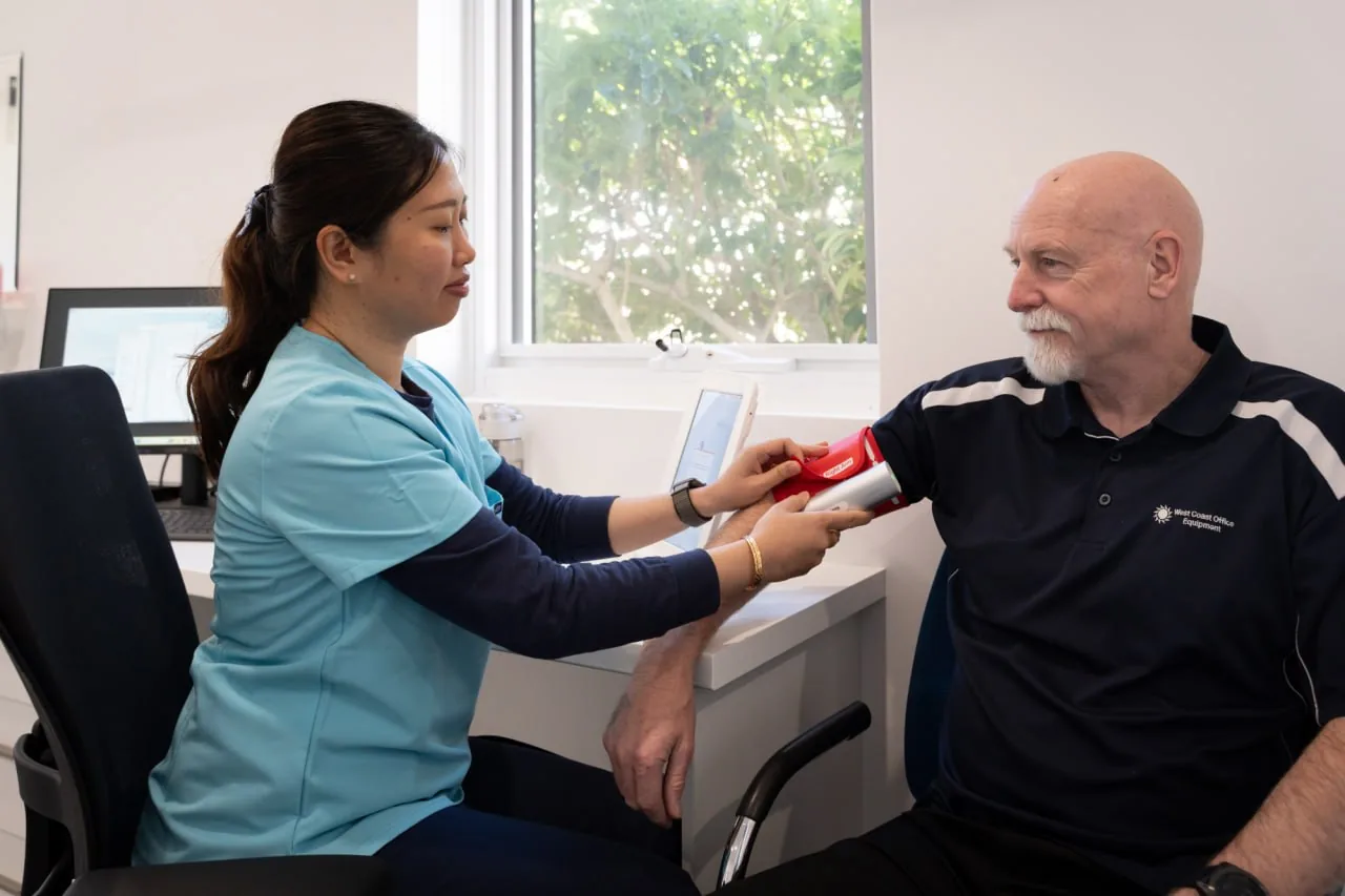 Minna Tran, Registered Nurse at Thorpe Street Health, taking a patient's blood pressure