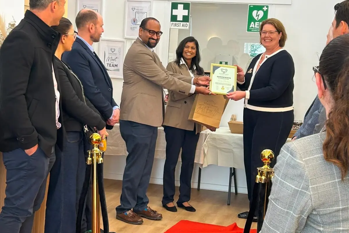 Rockingham Mayor Lorna Buchan being presented with a certificate by Dr Ashwin Menon and Dr Ranjitha Ananda Kumar at the opening